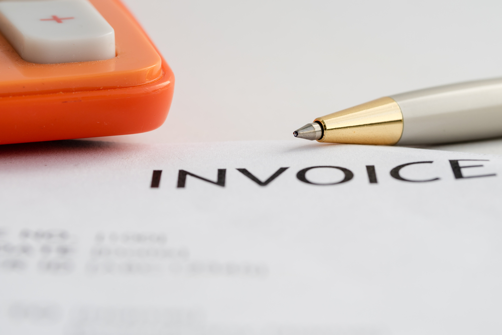 3PL invoice with calculator and pen - automated billing
