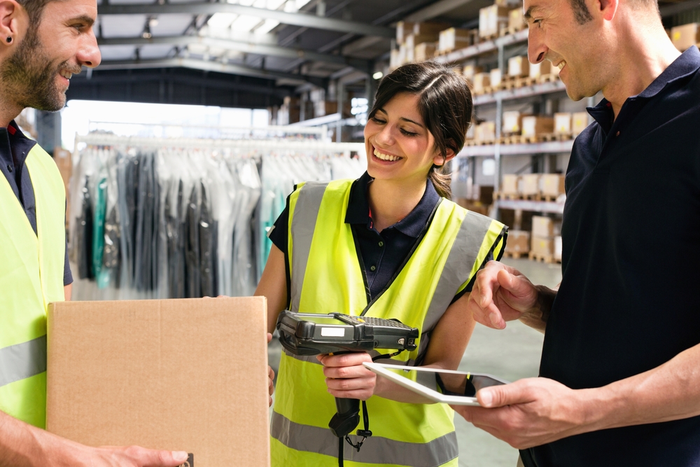 Warehouse workers using handheld scanners for inventory management